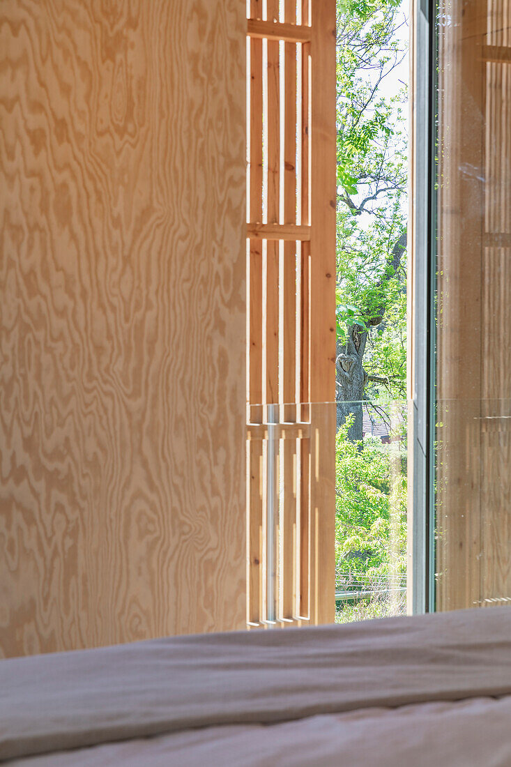 Movable wooden slats as privacy screen in the bedroom