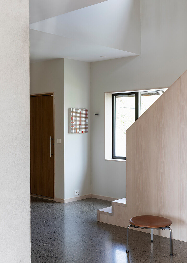 Hallway with terrazzo floor and wooden staircase