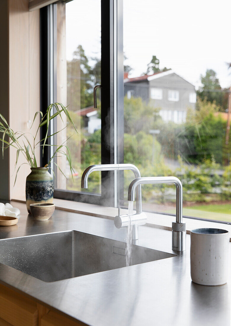 Sink with fittings in front of a window