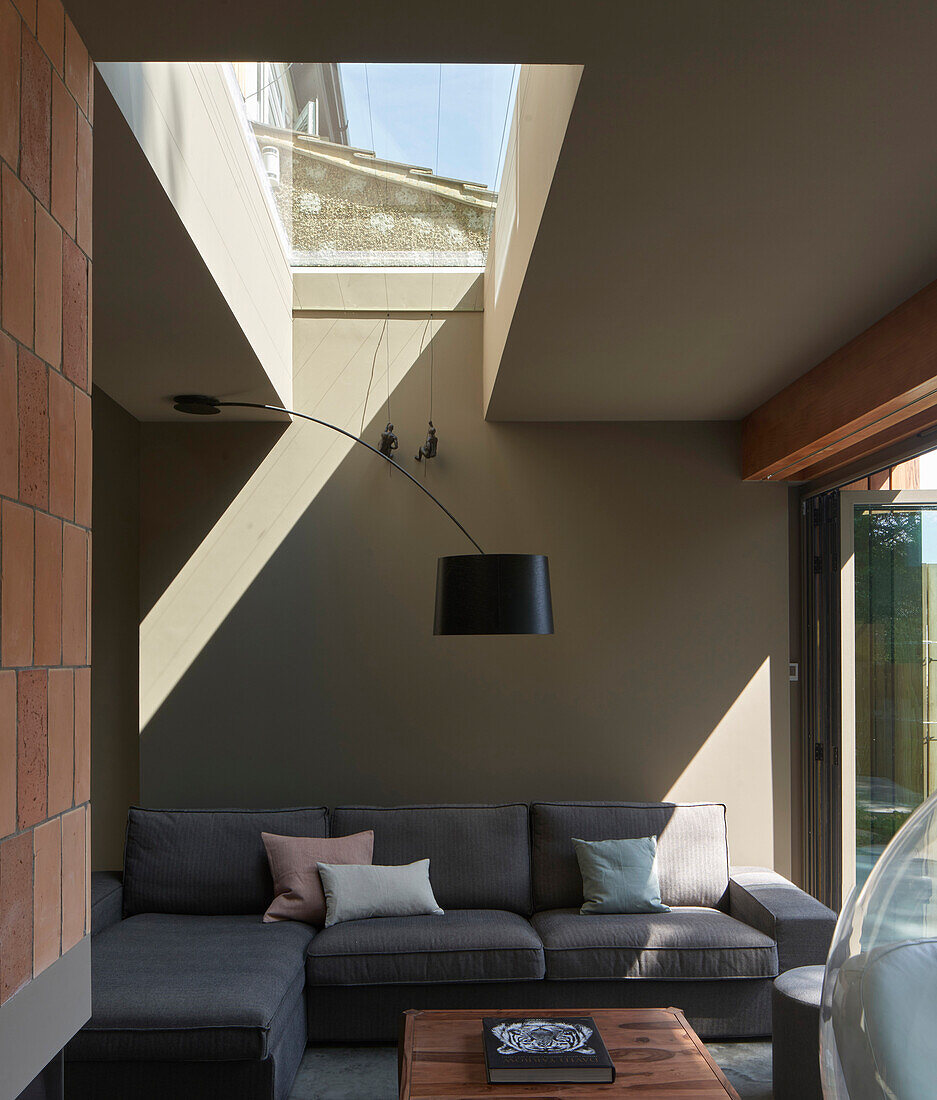 Grey sofa in living room with skylight