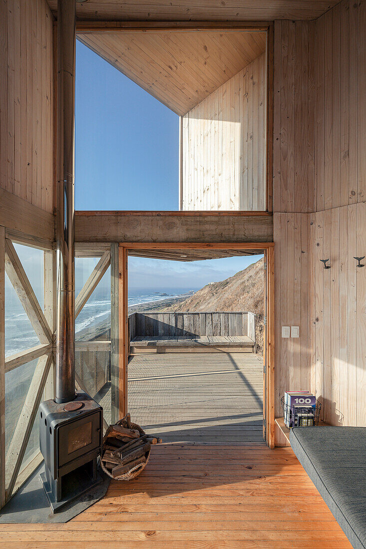 View from living area to terrace of a wooden house with sea view