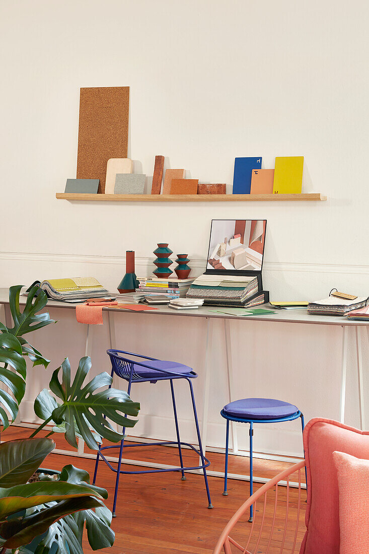 Work area with wall shelf, colorful accents and houseplant