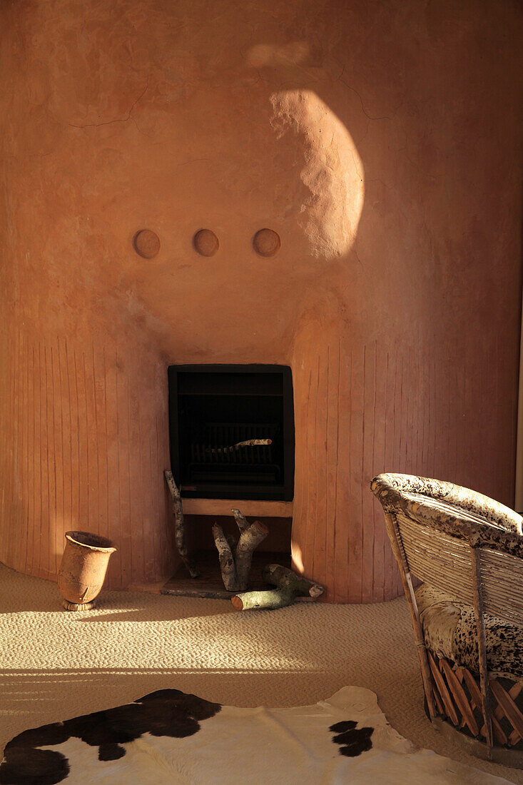 Fireplace in room with clay wall