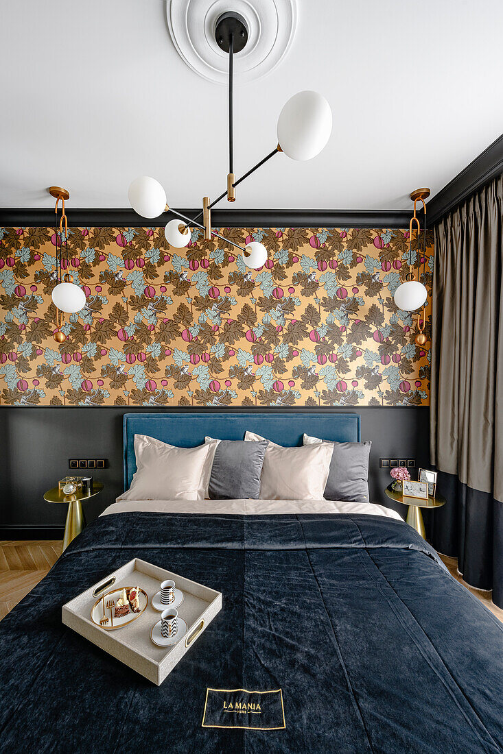 Doppelbett mit blauem Samtkopfteil, Tapete mit tropischem Muster an der Wand