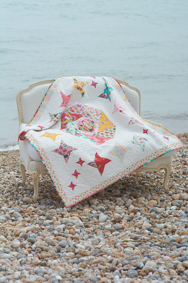 Colorful quilt on sofa by the water