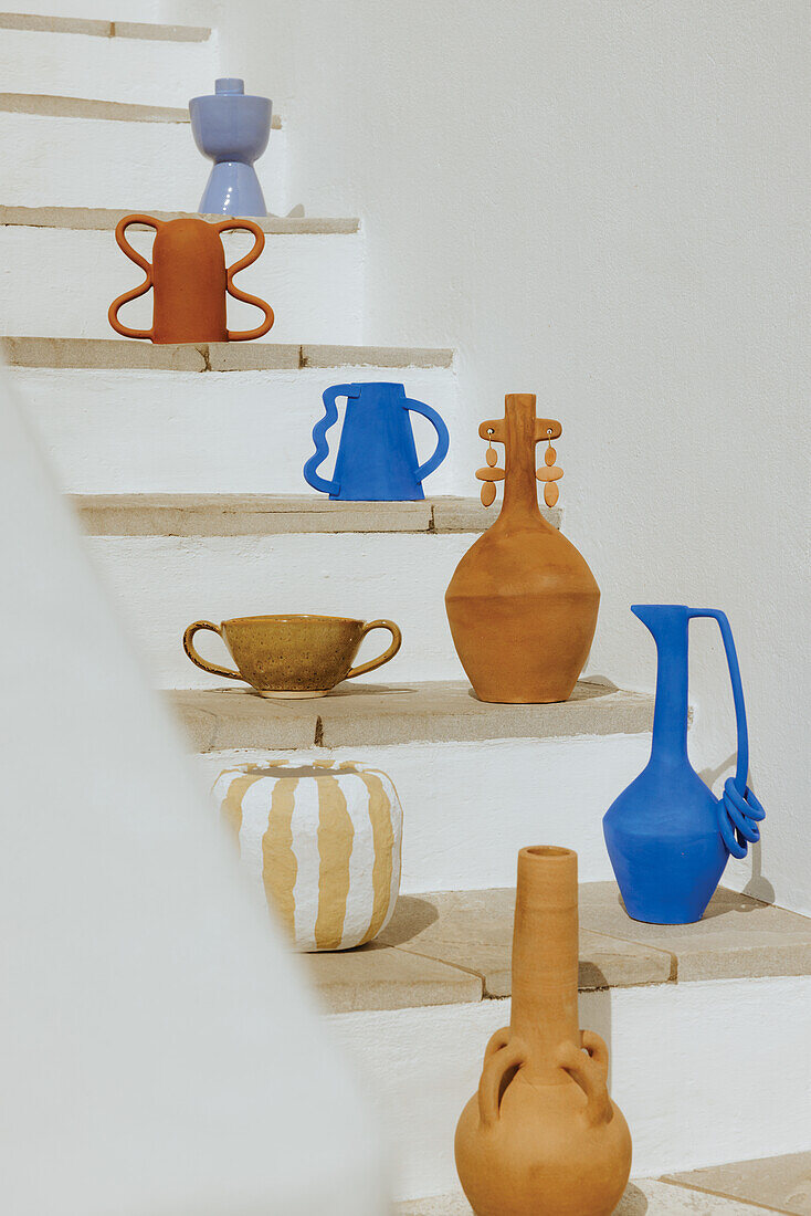 Vases, vessels, and candlesticks on stairs