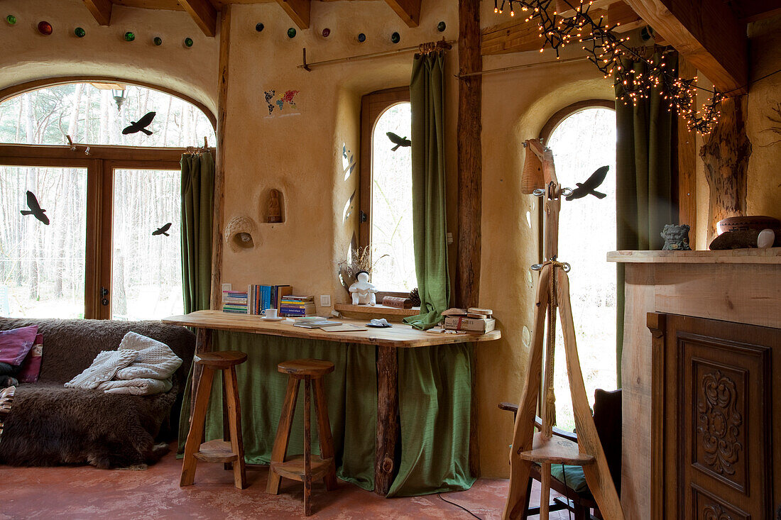 Wooden work table in rustic ambience with round-arched window