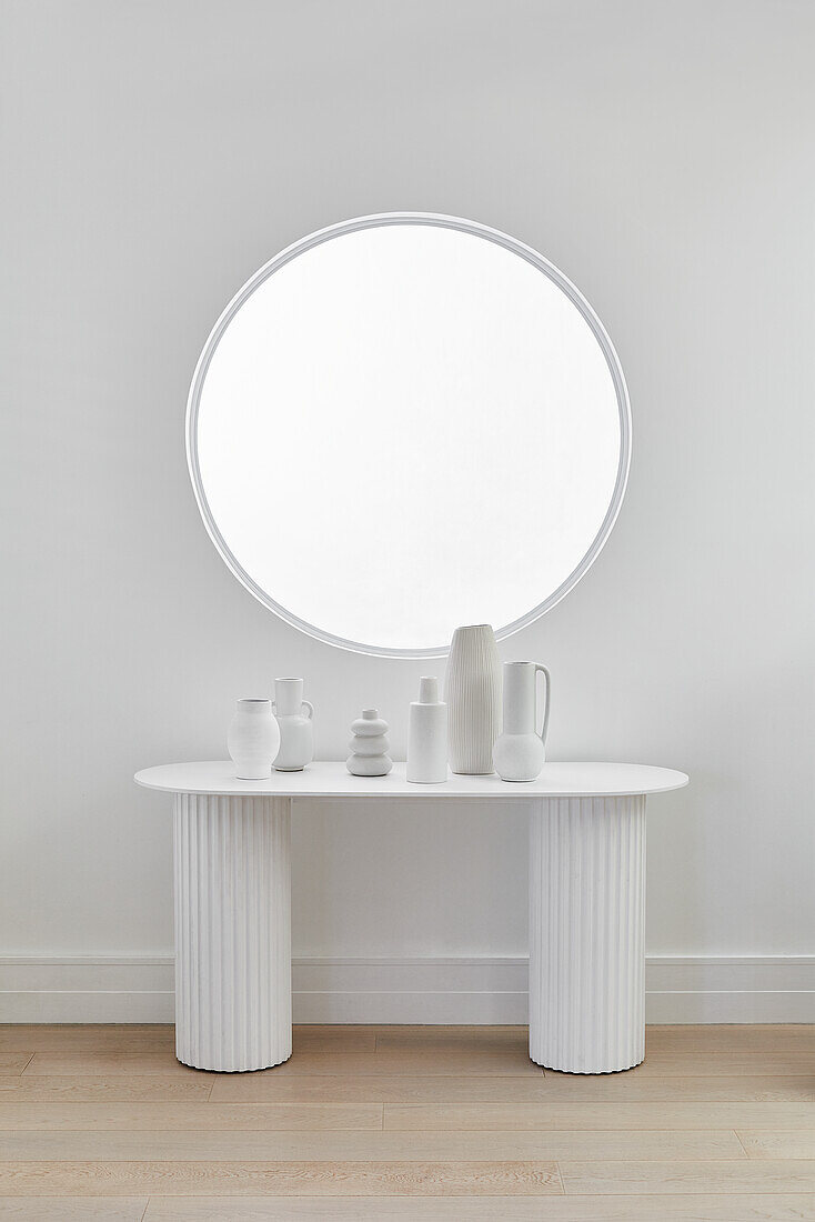 White column console with ceramic vessels
