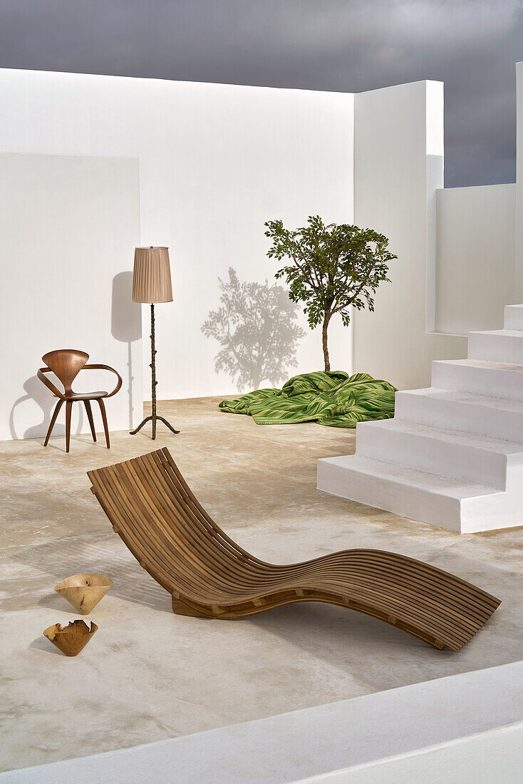 Designer lounger in the courtyard with white stairs