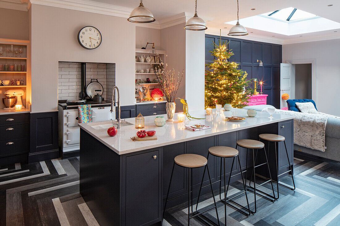 Festively decorated kitchen with Christmas tree in the background