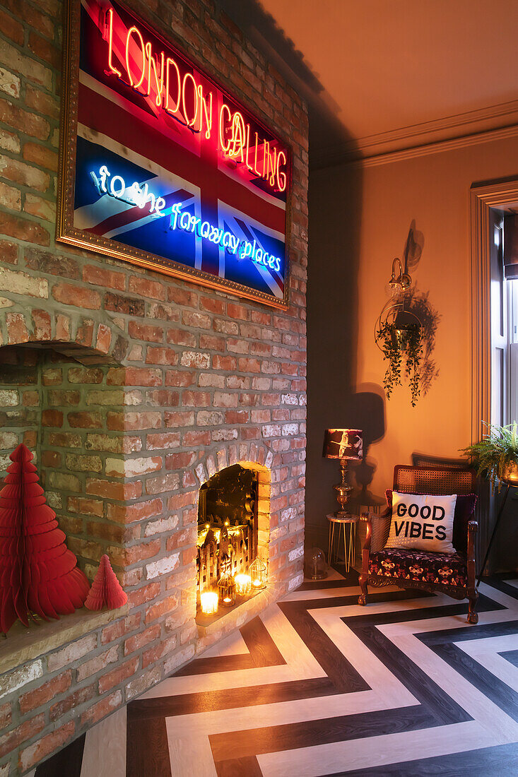 Living room with neon signs, brick wall, fireplace and floor with zigzag pattern