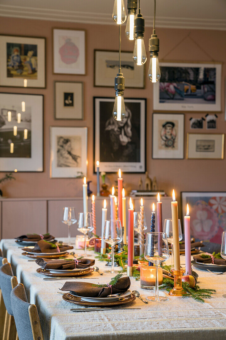 Festive table setting with candlelight and modern pendant lights