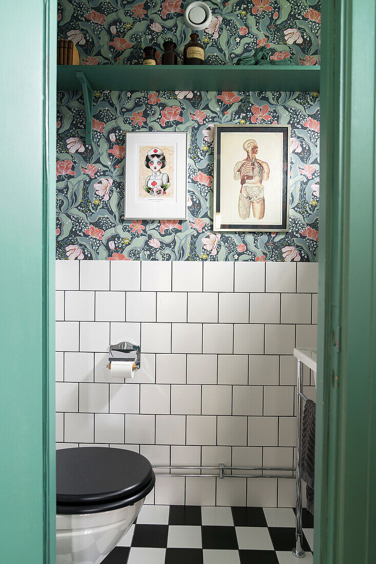 Bathroom with wallpaper in floral design, black and white checkered floor and white tiles