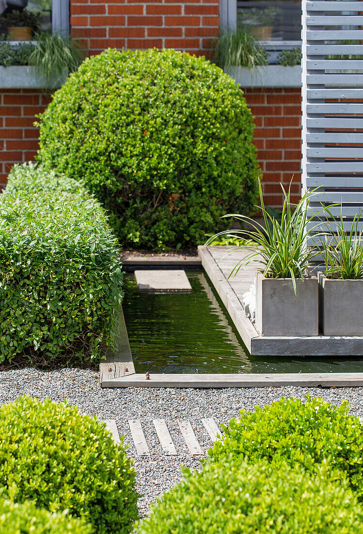 Carefully designed front garden with water feature in the centre