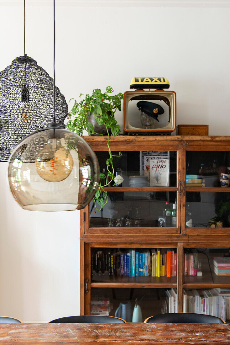 Wooden display case with books and vintage decorations