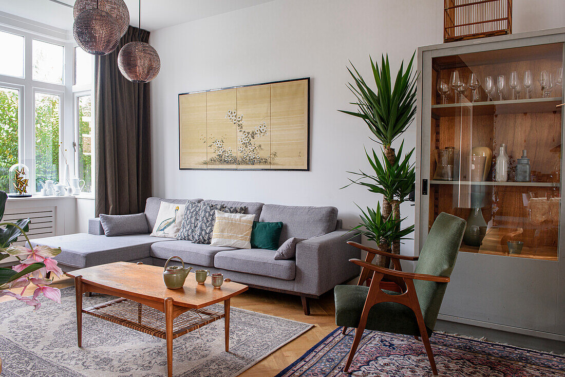 Bright living room with retro furniture and decorative houseplant