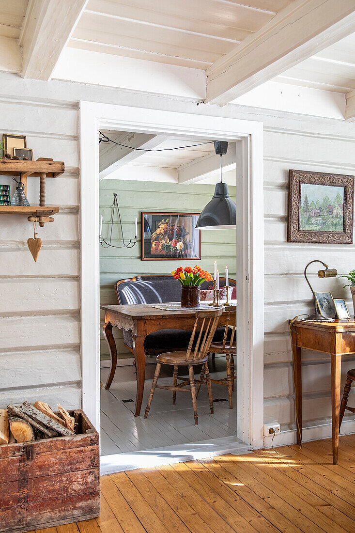 View of rustic dining room with wooden furniture and vintage picture