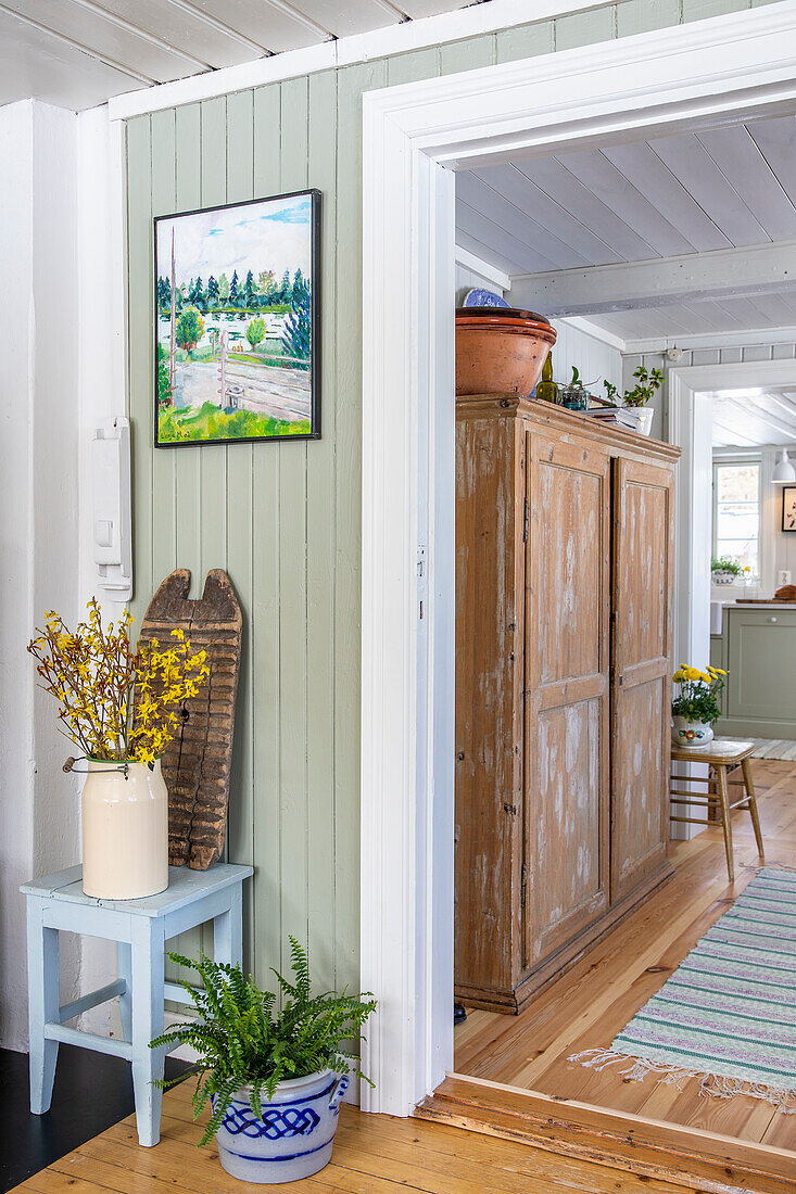 Holzschrank und Frühlingsdeko in einem Haus im Landhausstil