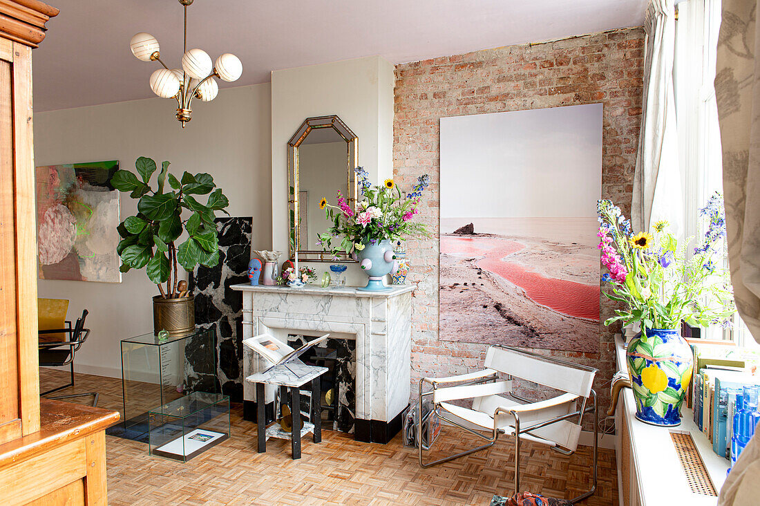 Living room with exposed brick wall, large picture and fireplace