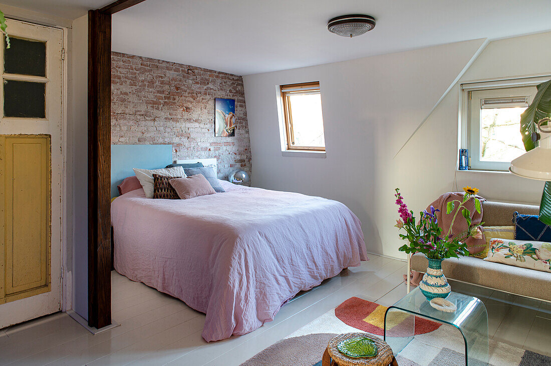 Bedroom with brick wall and colorful accents