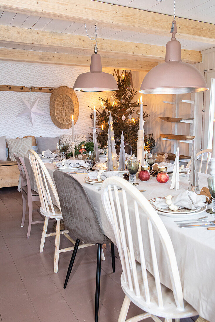 Festively set dining table, Christmas decorations and Christmas tree