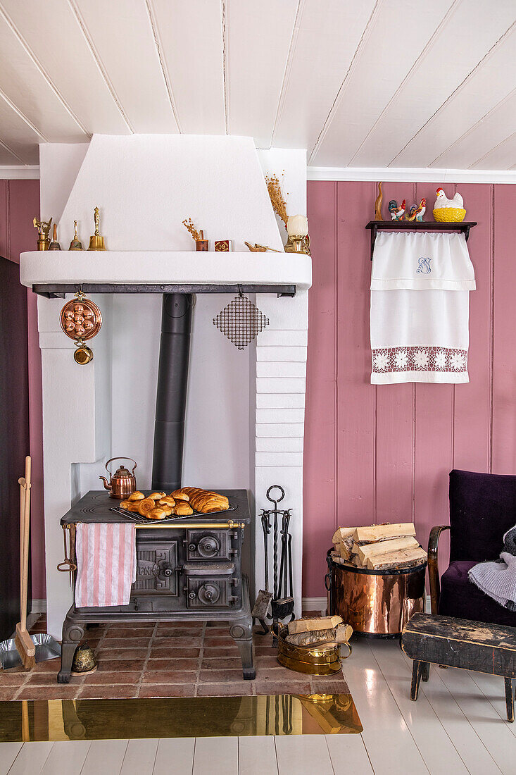 Wood-burning stove with baked goods on terracotta tiles, country style