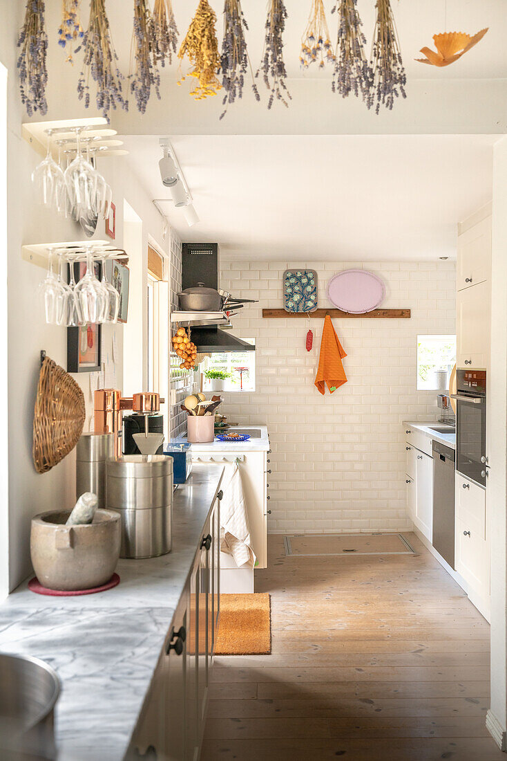 Kitchen with white tiles and dried lavender on the ceiling