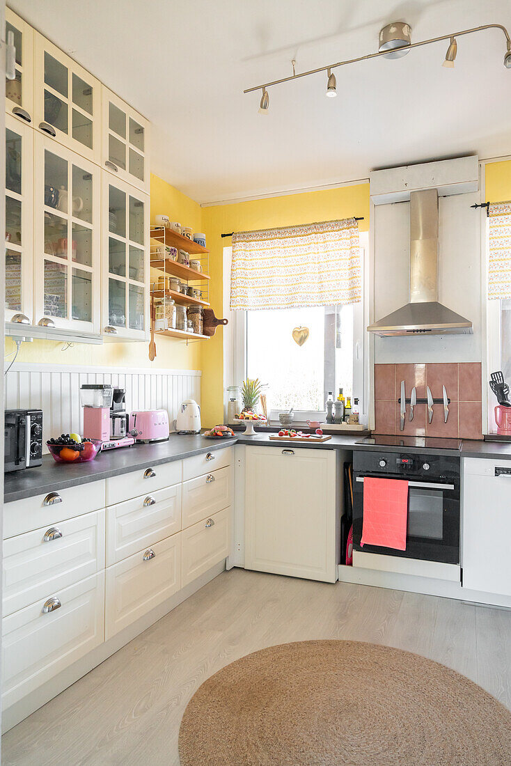 Kitchen with white cupboards and yellow-painted walls