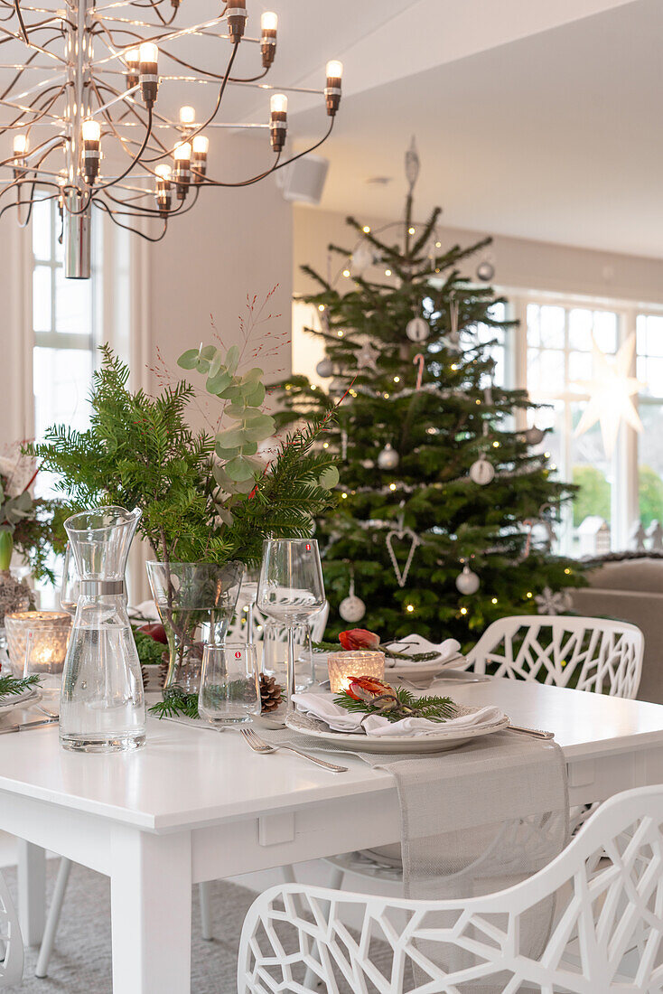 Christmas dining table with Christmas tree in the background