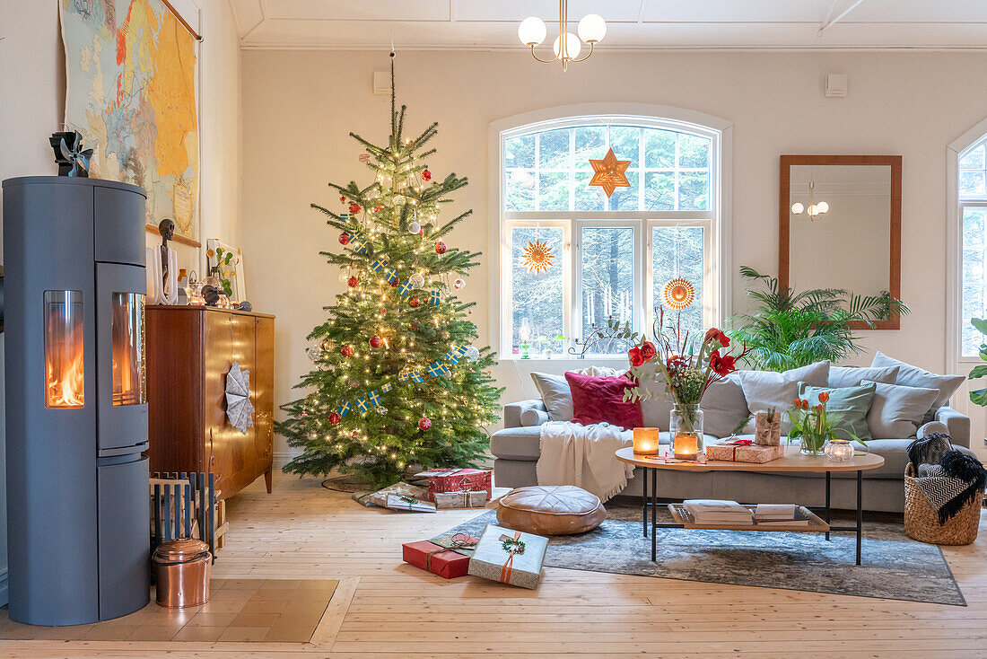 Living room decorated for Christmas with Christmas tree and wood-burning stove