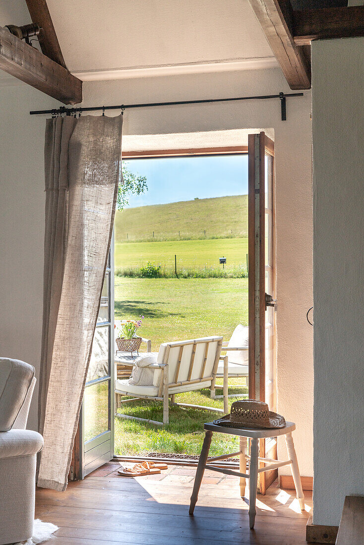 View of green hills from a rural living room