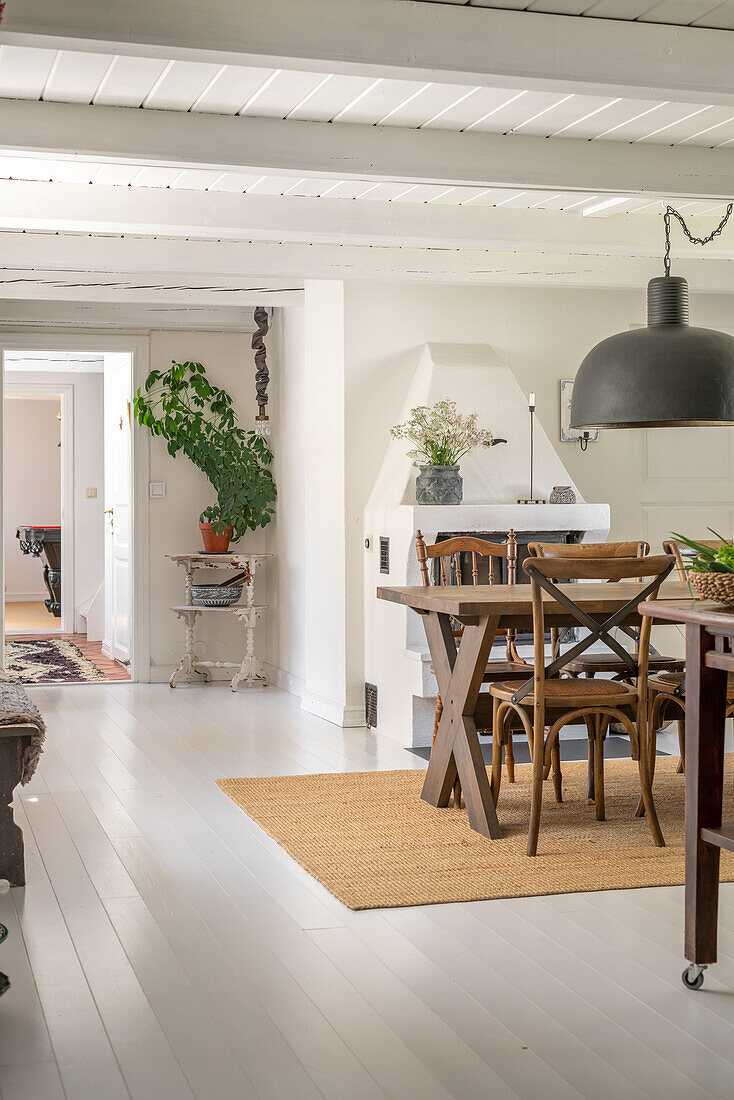 Dining area with wooden table, chairs and jute rug