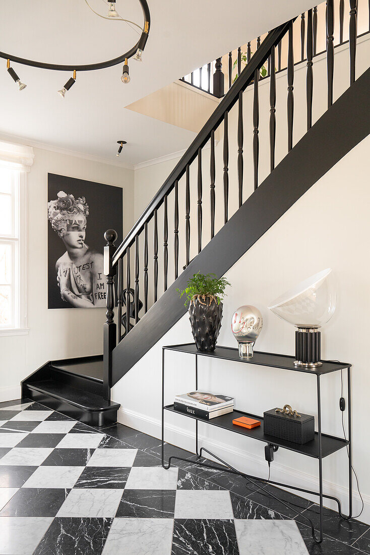 Black and white staircase with console and modern lighting