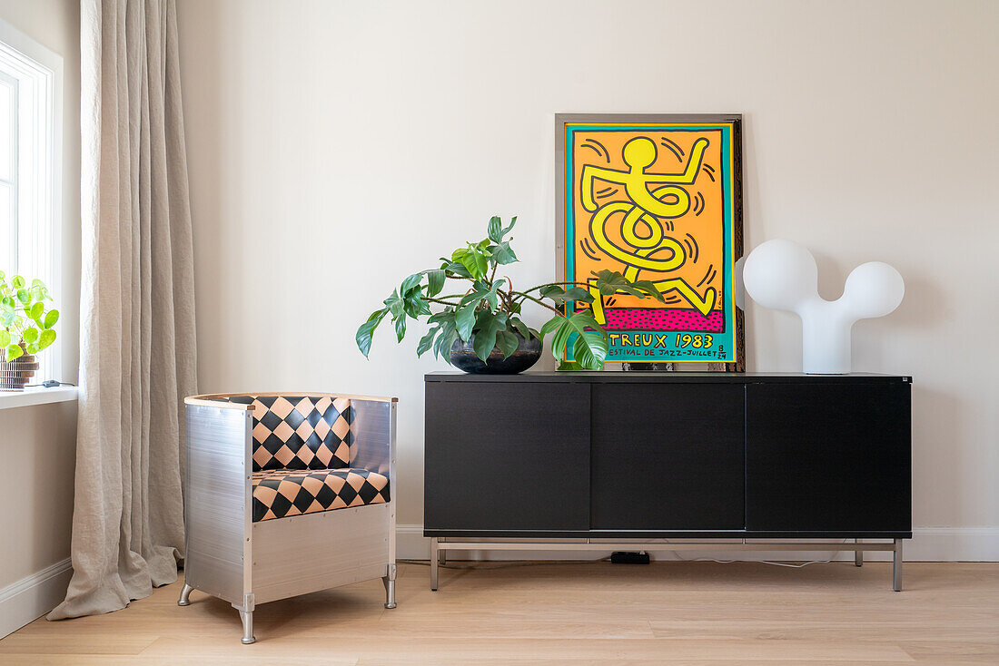 Sideboard with monstera, picture and modern lamp