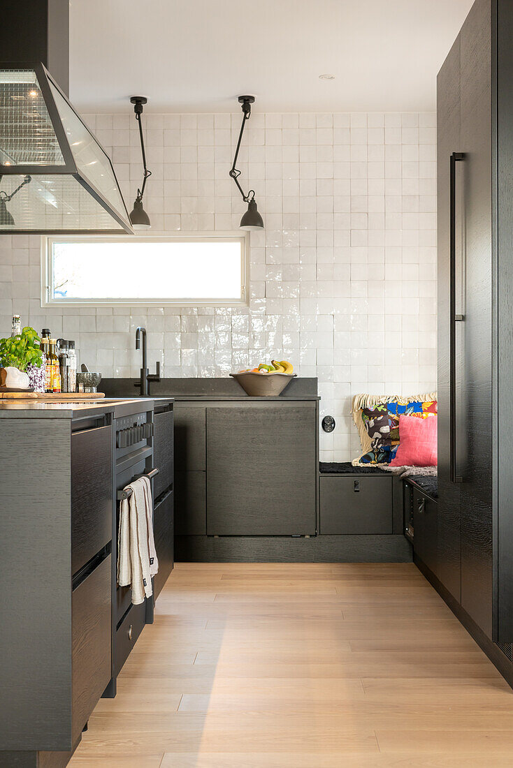 Modern kitchen with black cabinets and pendant lights