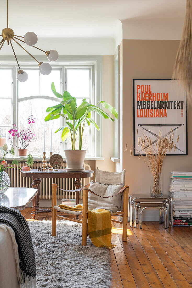 Living room with wooden furniture and framed poster on the wall