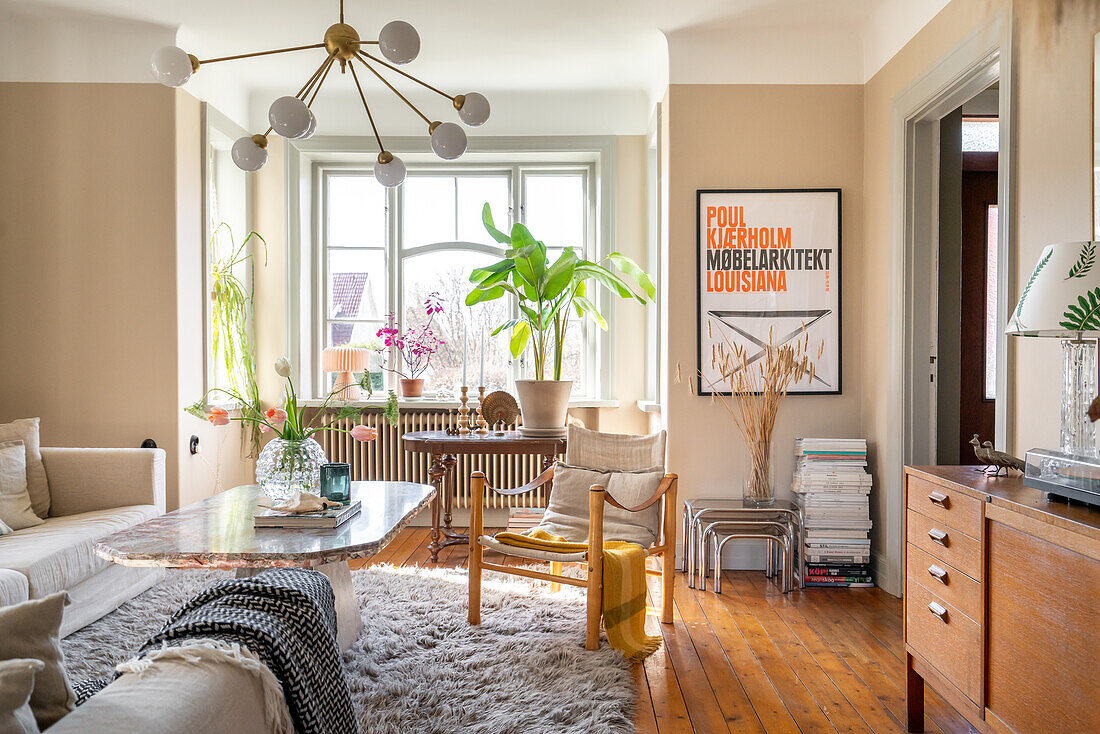 Living room with wooden furniture, flowers and plants