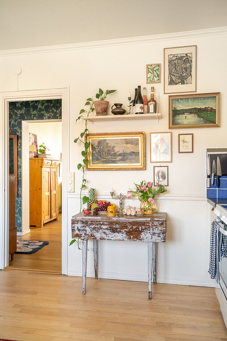 Vintage-style console table with decoration and picture gallery on the wall