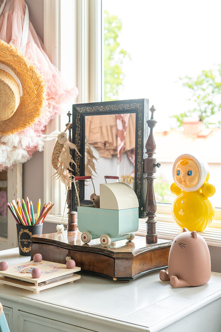 Table with mirror and toys in daylight