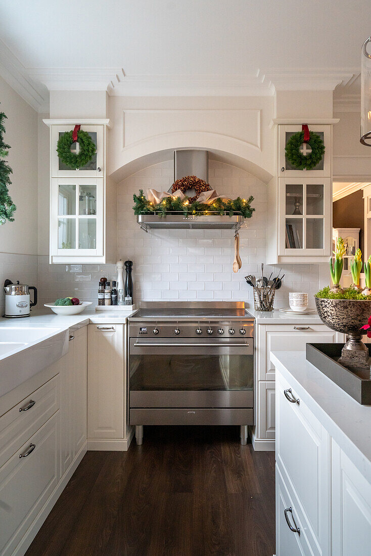 White kitchen with stainless steel hob and Christmas decorations