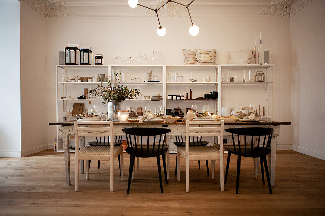 Set table, white shelf and modern ceiling lamp in the dining room