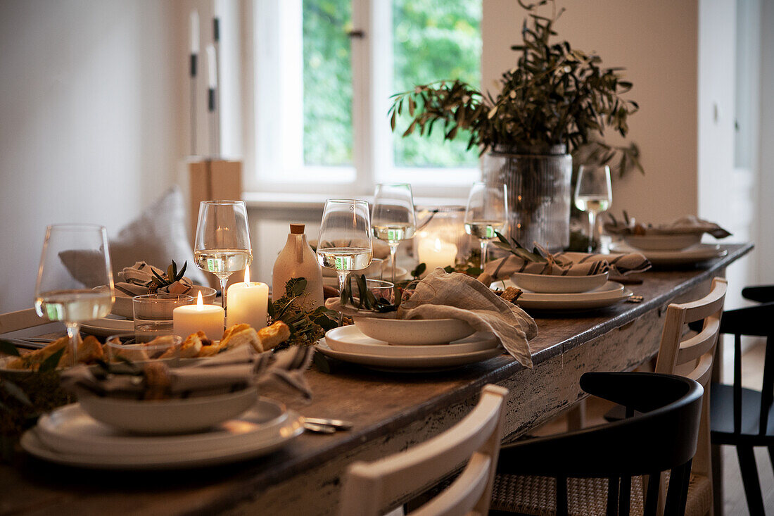 Set dining table with candles and plant decoration in the dining room