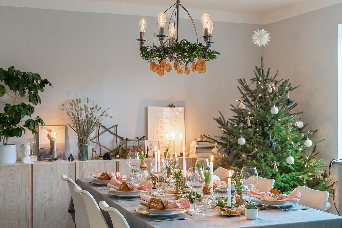 Festive dining table with Christmas tree and pendant light