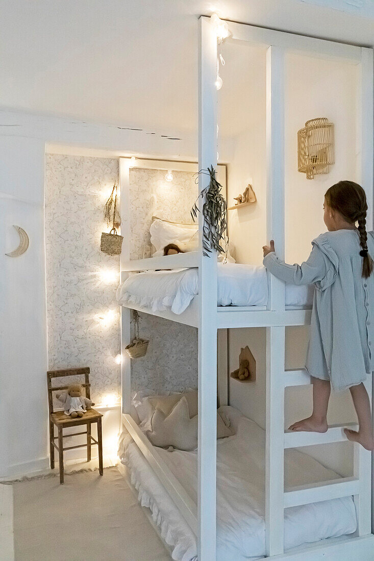 Children's room with bunk bed, fairy lights and minimalist decorations