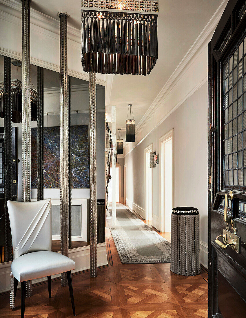 Elegant hallway with parquet flooring and stylish lighting
