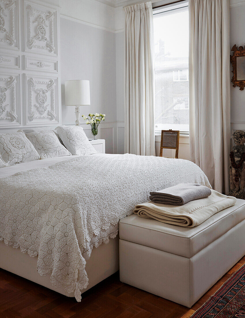Bright bedroom with white bed linen and vintage elements