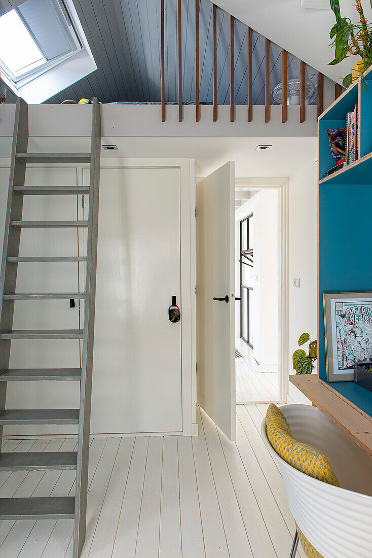 Hallway with white floorboards, wooden ladder and skylight