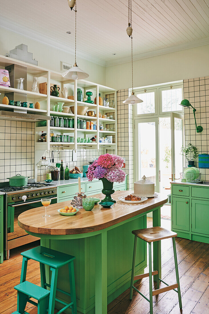 Helle Küche im Landhausstil mit grünen Schränken und Holzboden