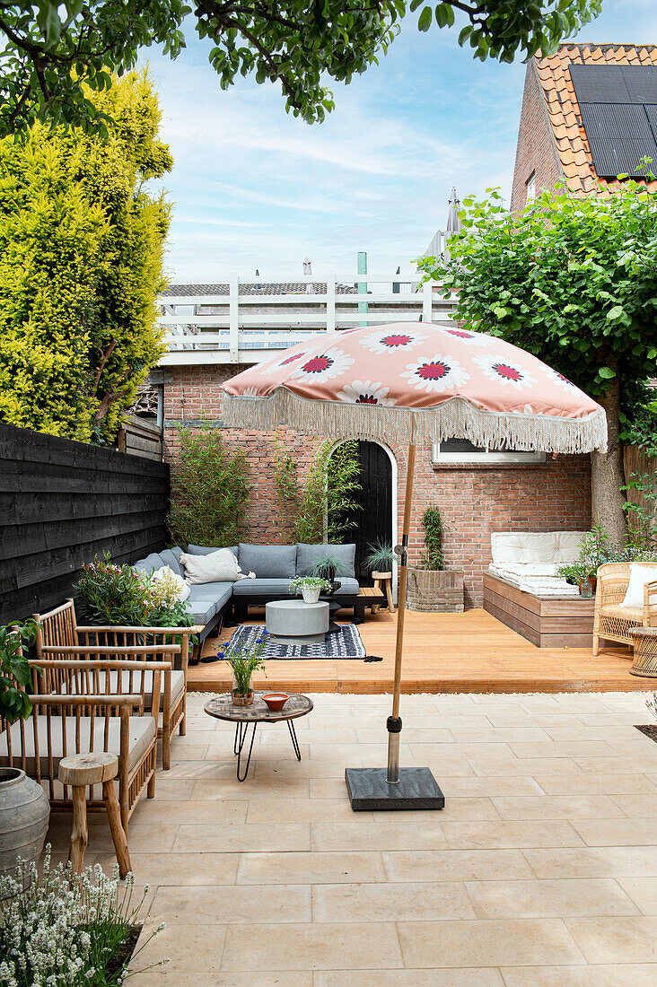 Large terrace with various seating furniture and patio umbrella
