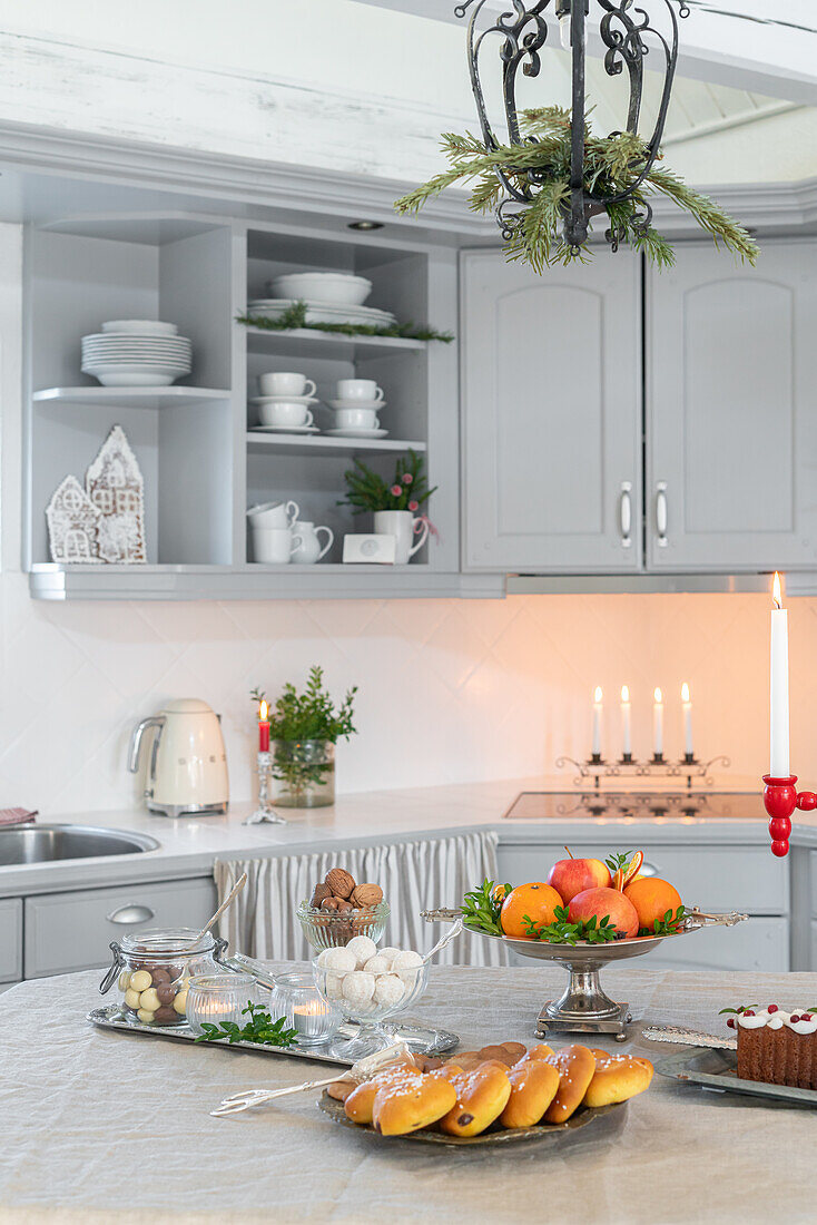 Brightly decorated kitchen with Christmas biscuits, sweets and fruit